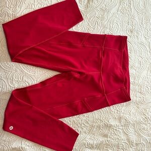 Lululemon high rise red leggings with side pockets.
